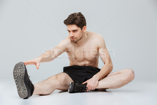 Portrait of a confident young half naked sportsman Stock photo © deandrobot