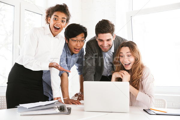 Stock photo: Group of excited young multiethnic businesspeople