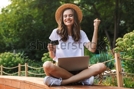 Elragadtatott fiatal lány ül laptop laptop számítógép park Stock fotó © deandrobot