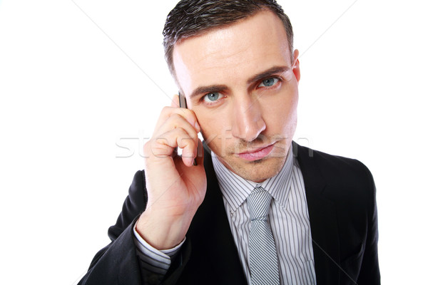 Business man talking on his mobile phone over white background Stock photo © deandrobot