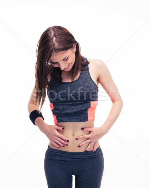 Happy fitness woman looking at her perfect body Stock photo © deandrobot