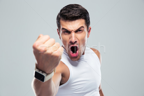 Angry man shouting over gray background Stock photo © deandrobot