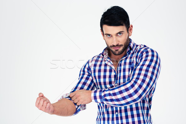 Portrait of a handsome man rolls up his sleeves Stock photo © deandrobot