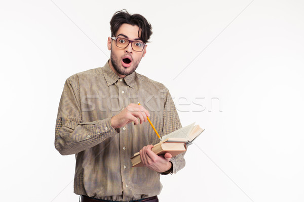 Shocked man standing with book Stock photo © deandrobot