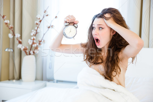 Woman waking up with alarm  Stock photo © deandrobot