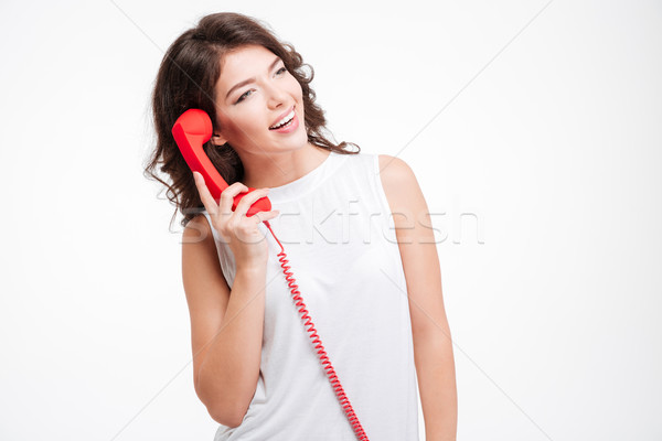 Smiling woman talking on the phone tube Stock photo © deandrobot