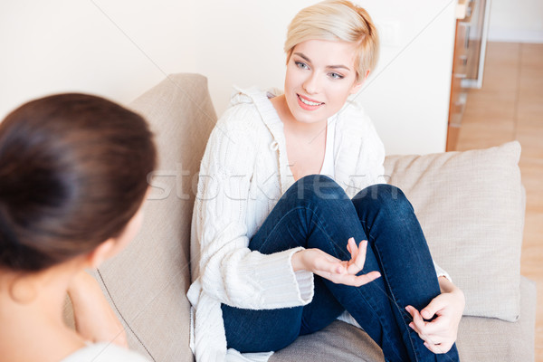 Két nő ül kanapé pletykál otthon nők Stock fotó © deandrobot