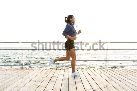 Stock photo: Handsome african american young sportsman running on pier