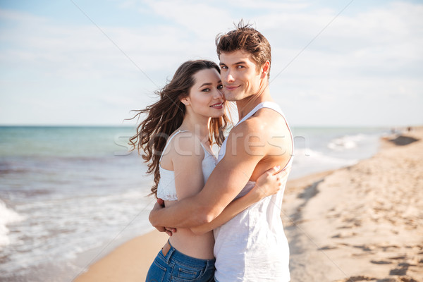 Сток-фото: пару · Постоянный · пляж · улыбаясь · красивой