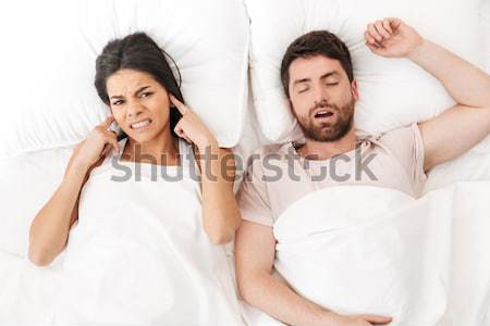 Two attractive women with cupcakes sitting in bed Stock photo © deandrobot