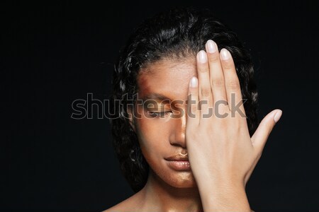 African young woman covered half of her face by hand Stock photo © deandrobot