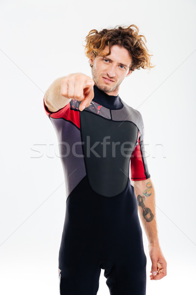 Concentrated man in diving suit pointing finger at camera Stock photo © deandrobot