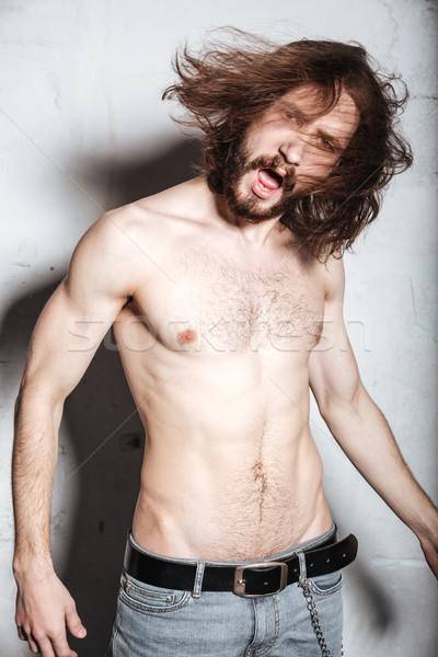 Screaming emotional young bearded hipster man Stock photo © deandrobot