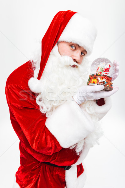 Man santa claus standing and holding snow globe Stock photo © deandrobot
