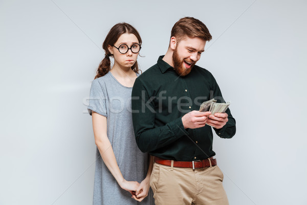 7953832_stock-photo-upset-female-nerd-with-bearded-man-which-recounts-money.jpg