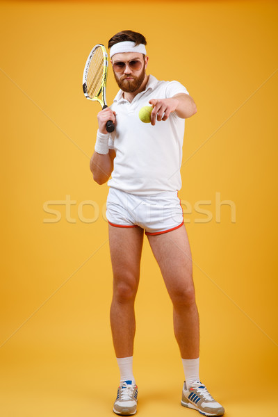 Vertical image of sportsman with tennis racquet pointing at camera Stock photo © deandrobot