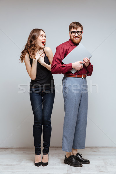 Vertical image of Happy Surprised woman with Male nerd Stock photo © deandrobot