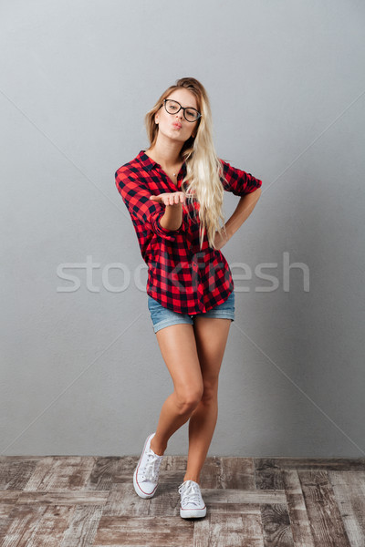 Amazing young blonde woman blowing kisses. Stock photo © deandrobot