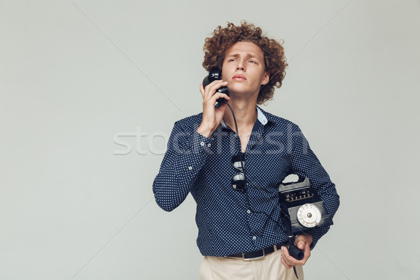 Handsome retro man with telephone in hands. Stock photo © deandrobot