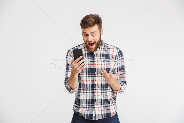 Stock photo: Portrait of a surprised young man in plaid shirt