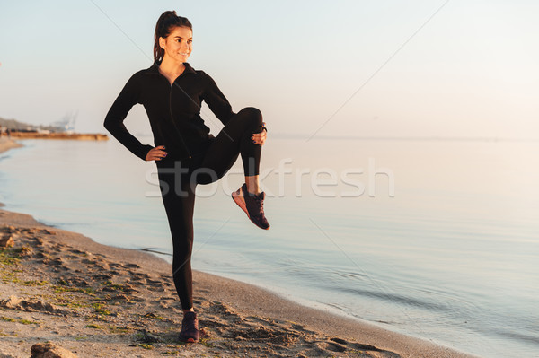 Fit young sportswoman doing stretching exercises Stock photo © deandrobot