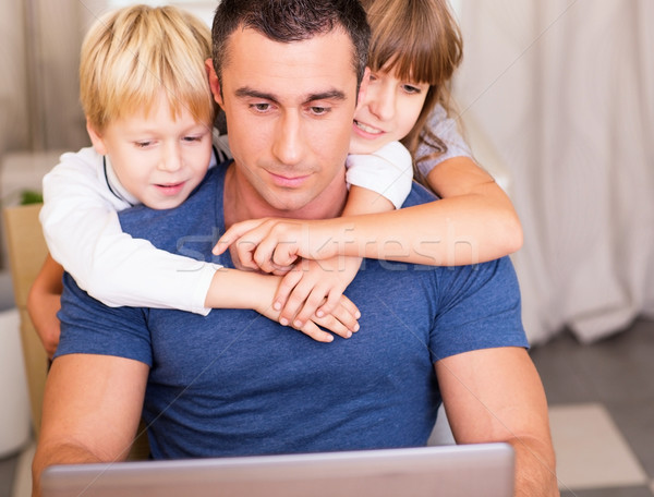 Father and children at home with laptop computer Stock photo © deandrobot