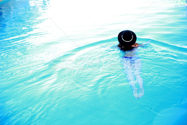 Vue arrière portrait femme piscine eau mer [[stock_photo]] © deandrobot