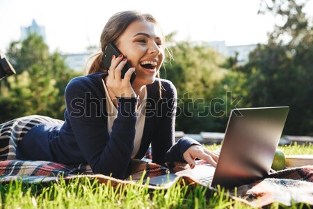 Woman talking on the phone outdoors Stock photo © deandrobot