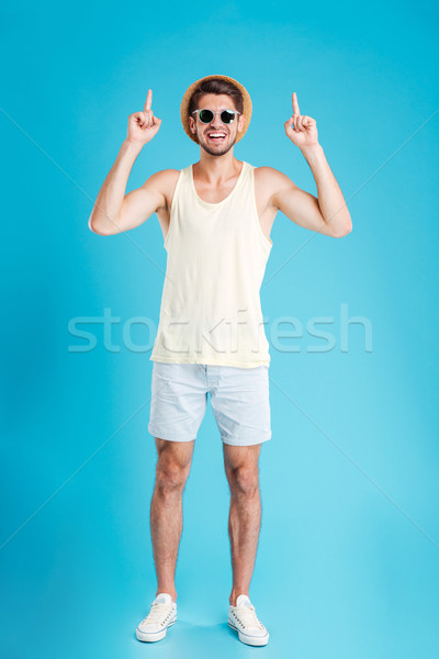 Heiter junger Mann Hinweis up beide Hände Stock foto © deandrobot