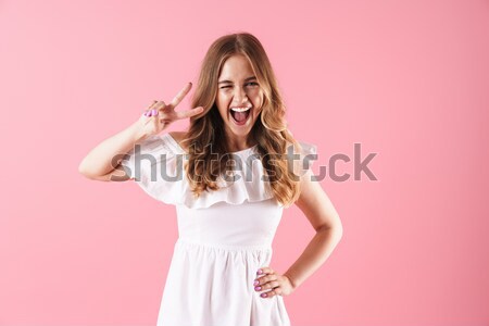 Happy smiling brunette in bikini posing on blue background Stock photo © deandrobot