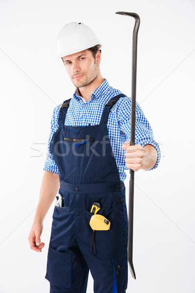 Serious male builder holding crowbar Stock photo © deandrobot