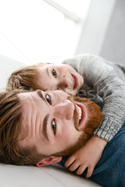 Happy bearded father playing with his little cute son Stock photo © deandrobot