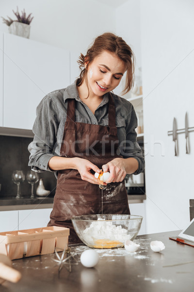 Young lady cooking the dough. Stock photo © deandrobot