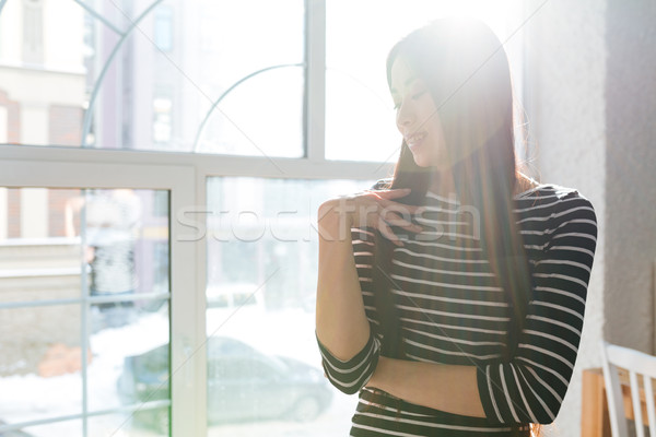 Pretty Asian woman near the window in cafeteria Stock photo © deandrobot