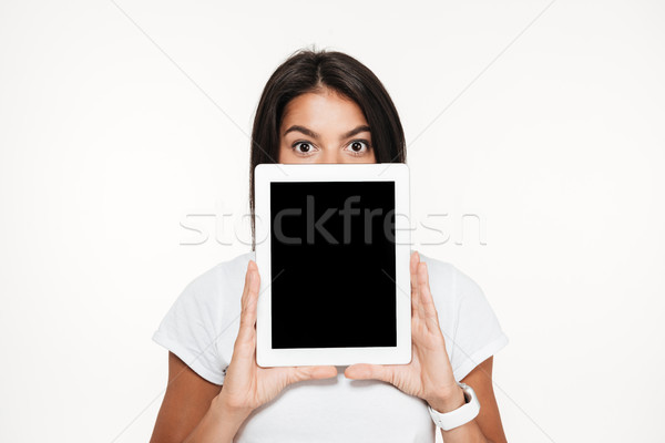 Portrait of a young brunette woman covering face Stock photo © deandrobot