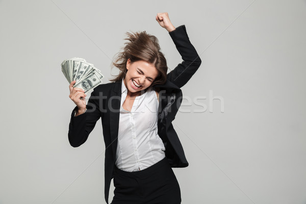 Portrait of a thrilled excited businesswoman in suit Stock photo © deandrobot