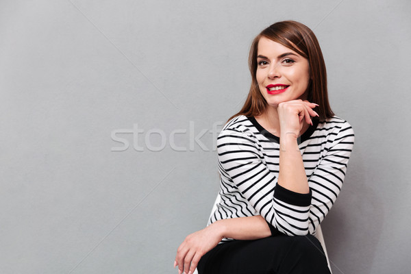 Portrait of a lovely woman sitting on chair Stock photo © deandrobot