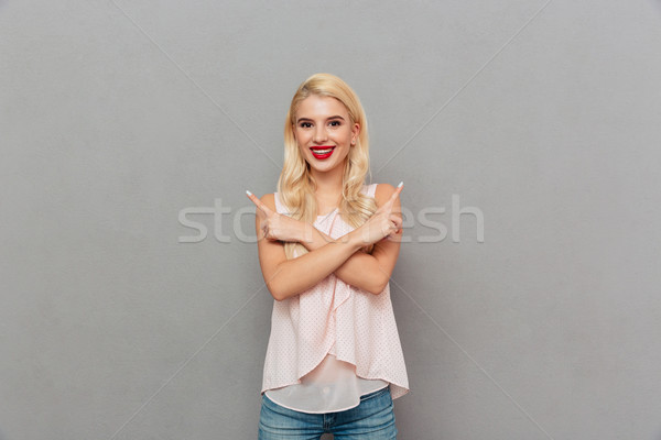 Portrait of a joyful girl standing Stock photo © deandrobot