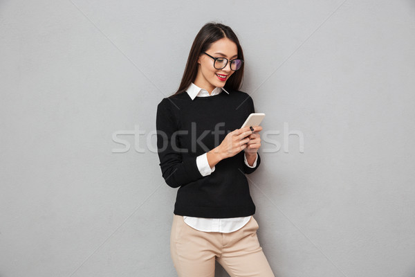Smiling asian woman in business clothes and eyeglasses Stock photo © deandrobot