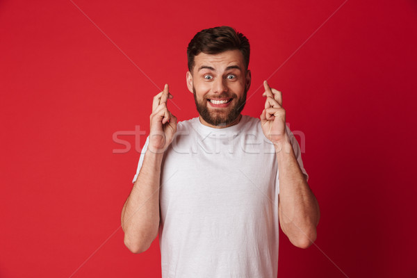 Hopeful young man make please gesture. Stock photo © deandrobot