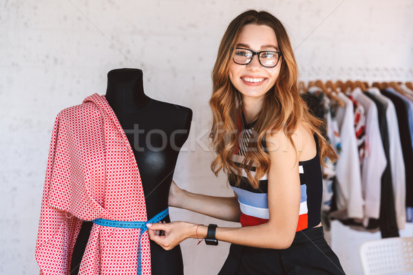 Positive young woman clothes designer at the atelier Stock photo © deandrobot