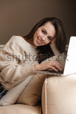 Young pensive woman in cozy warm clothings with cup of coffee Stock photo © deandrobot