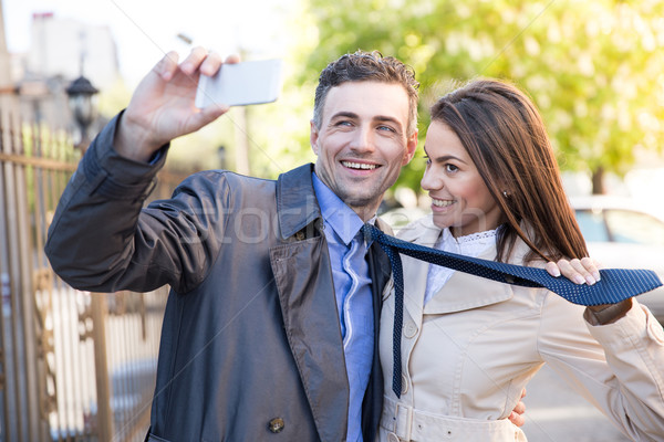 Smiling couple making selfie photo outdoors Stock photo © deandrobot