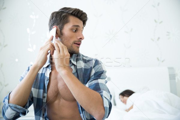 Man talking on the phone  Stock photo © deandrobot