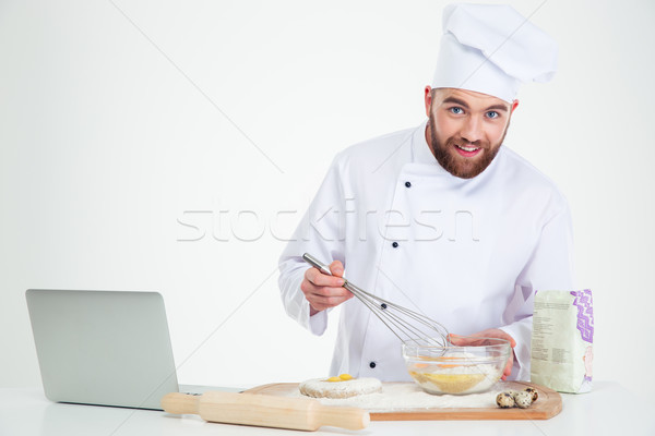 Stock photo: Smiling male chef cook baking with laptop