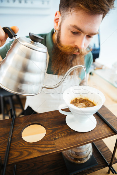 Barista pouring water on coffee ground with filter  Stock photo © deandrobot
