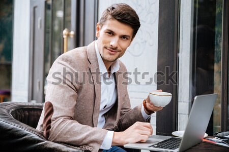 Empresário copo café trabalhando laptop Foto stock © deandrobot