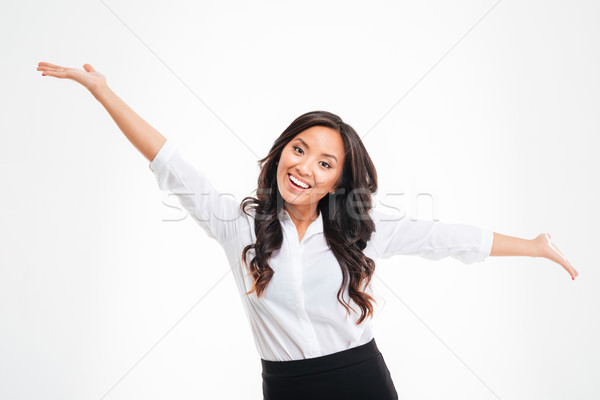Portrait of a happy asian busineswoman with raised hands up Stock photo © deandrobot