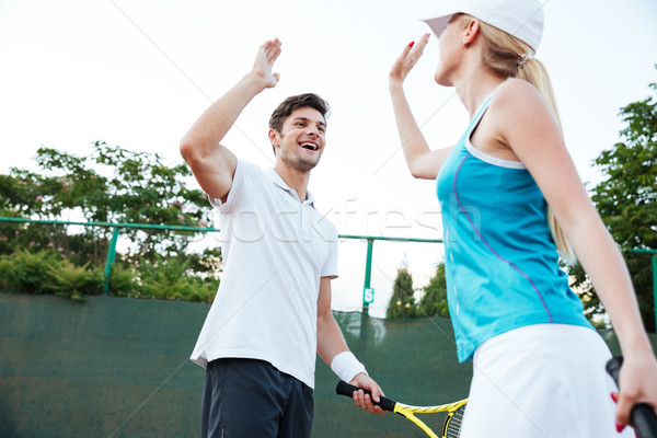 Happy tennis players Stock photo © deandrobot