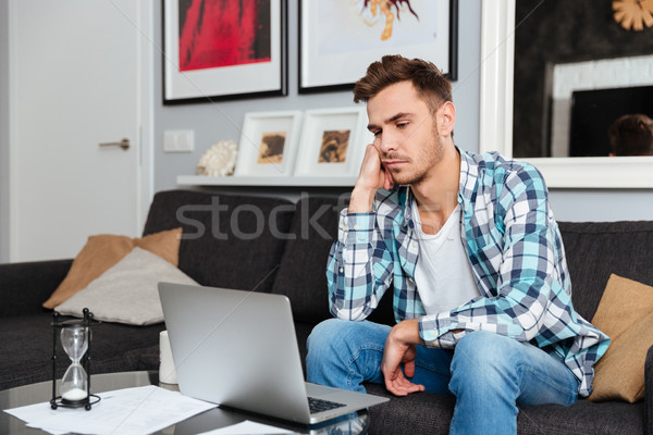 Tired bristle man using laptop computer Stock photo © deandrobot